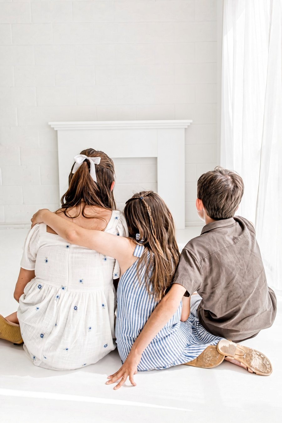Sacha's three children sitting together, arms around each other.