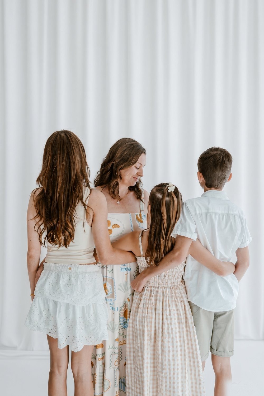 Sacha Russo with her three children, arms around each other.